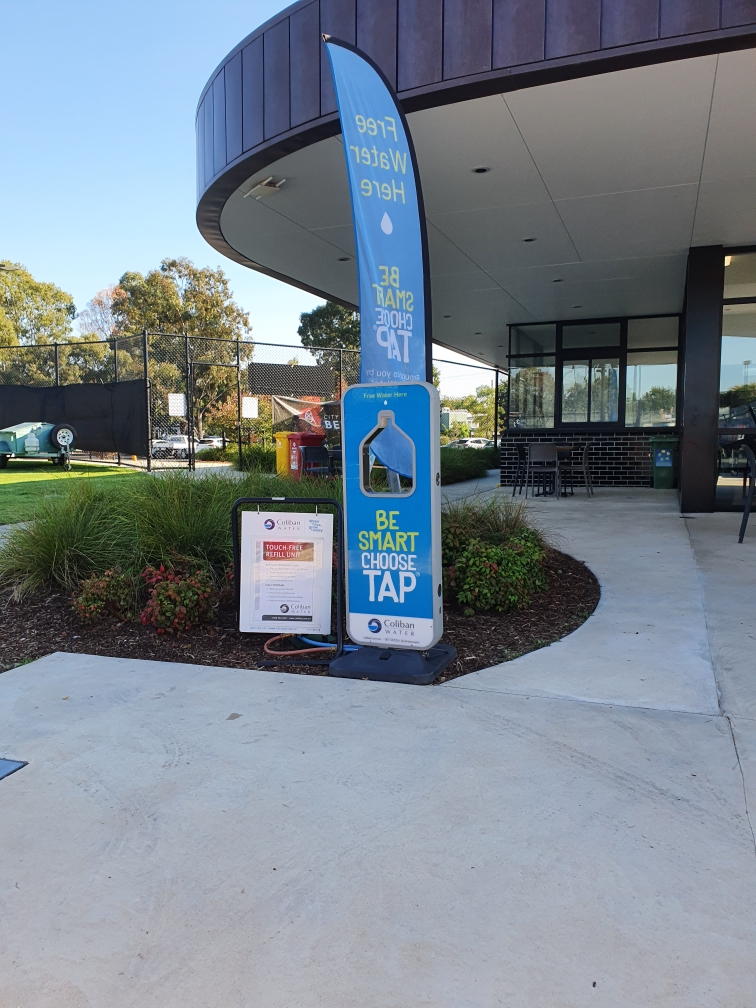 Our portbale refill unit setup outside the bendigo tennis centre with A-frame instructions and choose tap flag