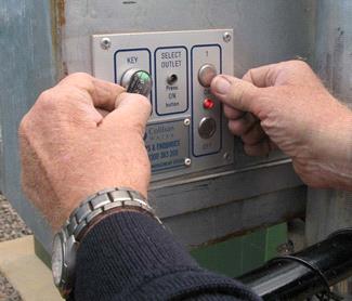 Close up of hands demonstrating use of standpipe